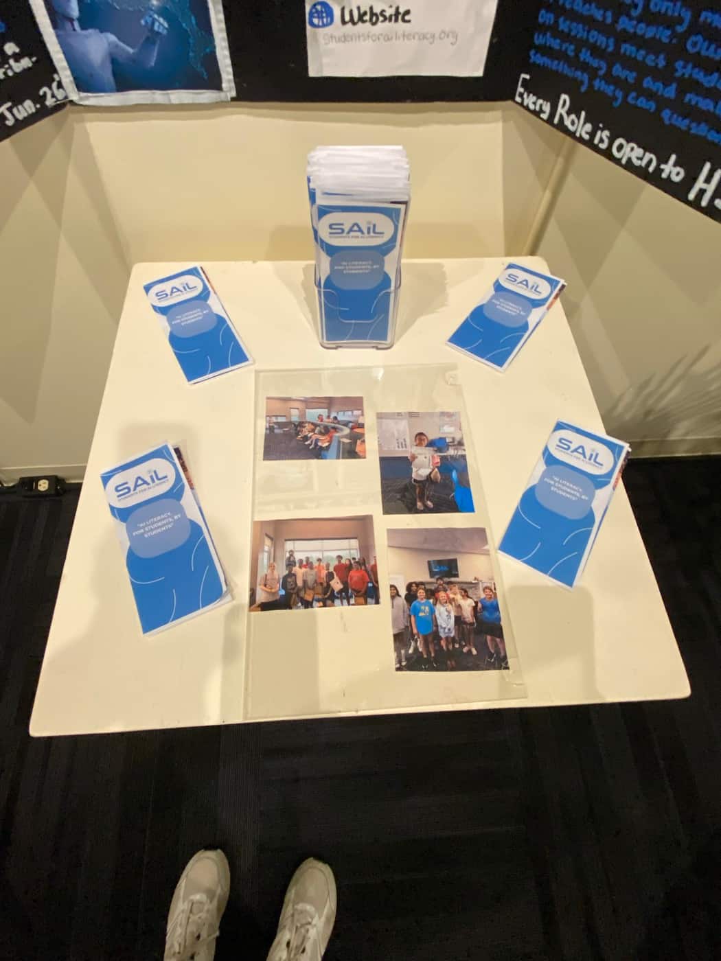 SAIL brochures and a flyer dispenser arranged on the display plinth, reading 'AI literacy for students, by students'